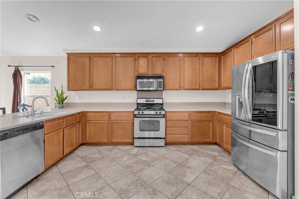 48734 Chichen Itza Road Coachella, CA 92236 - Photo 3 of 18 a kitchen with stainless steel appliances granite countertop a refrigerator and a sink