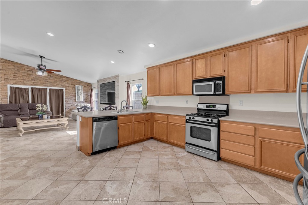 48734 Chichen Itza Road Coachella, CA 92236 - Photo 6 of 18 a kitchen with stainless steel appliances granite countertop a stove sink and cabinets