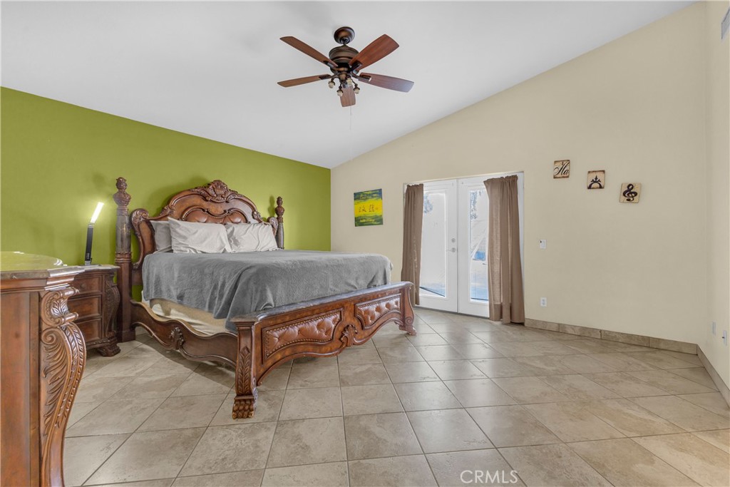 48734 Chichen Itza Road Coachella, CA 92236 - Photo 7 of 18 a bedroom with a bed and a chandelier