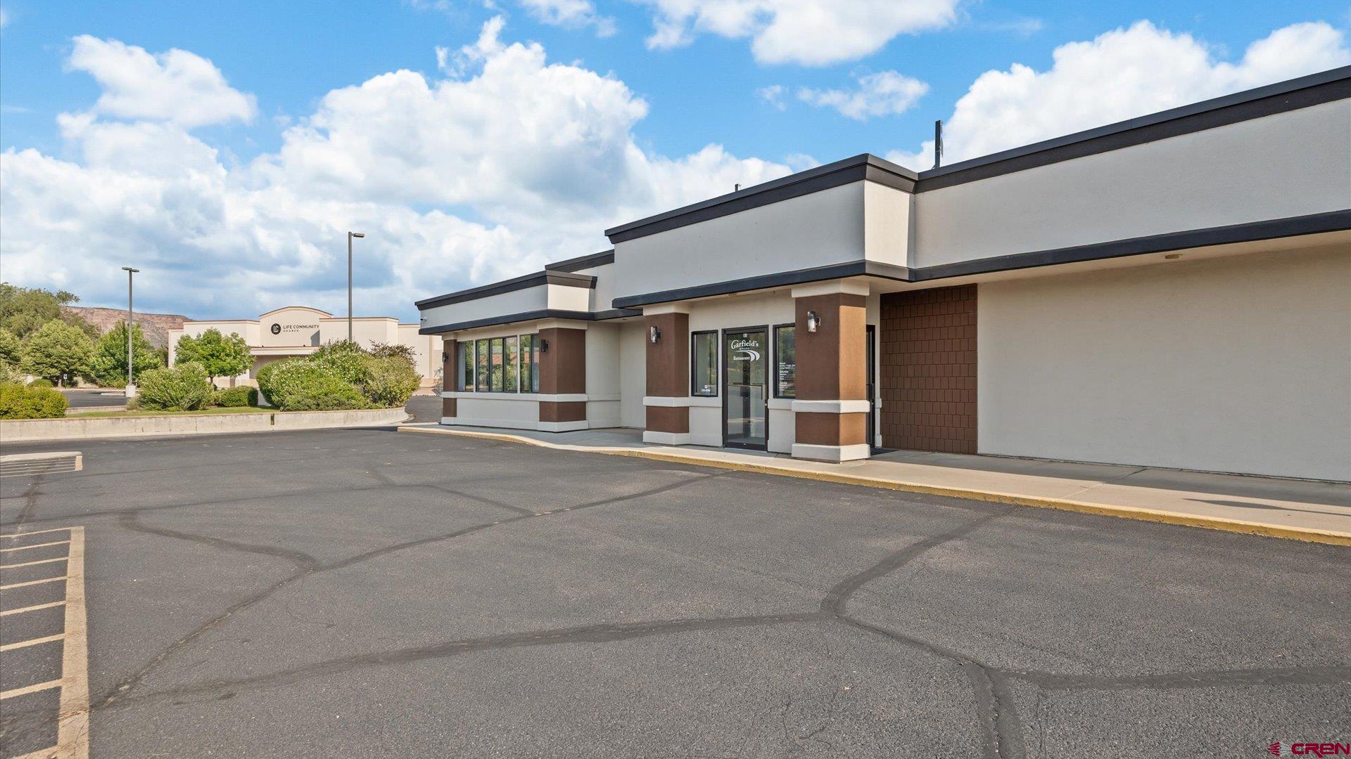 2148 Broadway, Unit C6 Grand Junction, CO 81507 - Photo 1 of 2 a view of a white house next to a yard