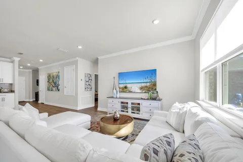 a view of a house with a big yard and large trees