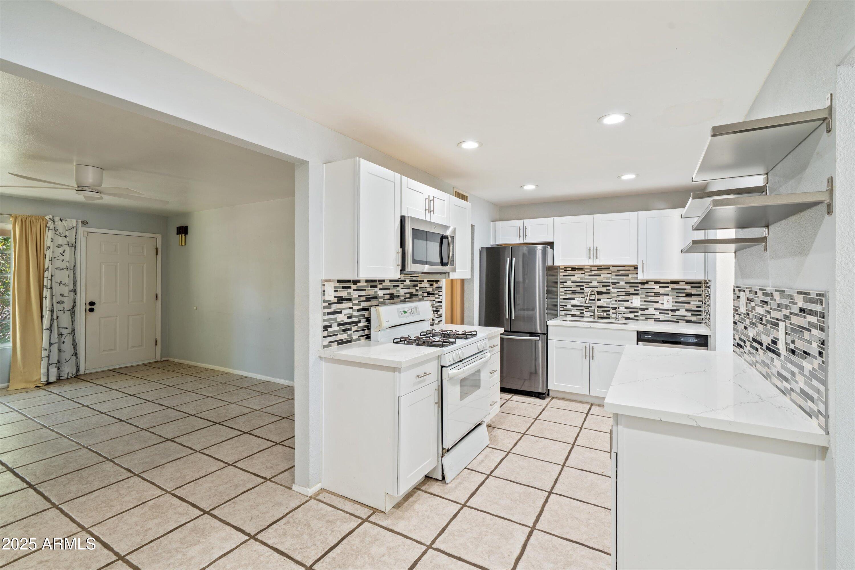 8216 North 9th Street Phoenix, AZ 85020 - Photo 7 of 39 a kitchen with a stove and white cabinets