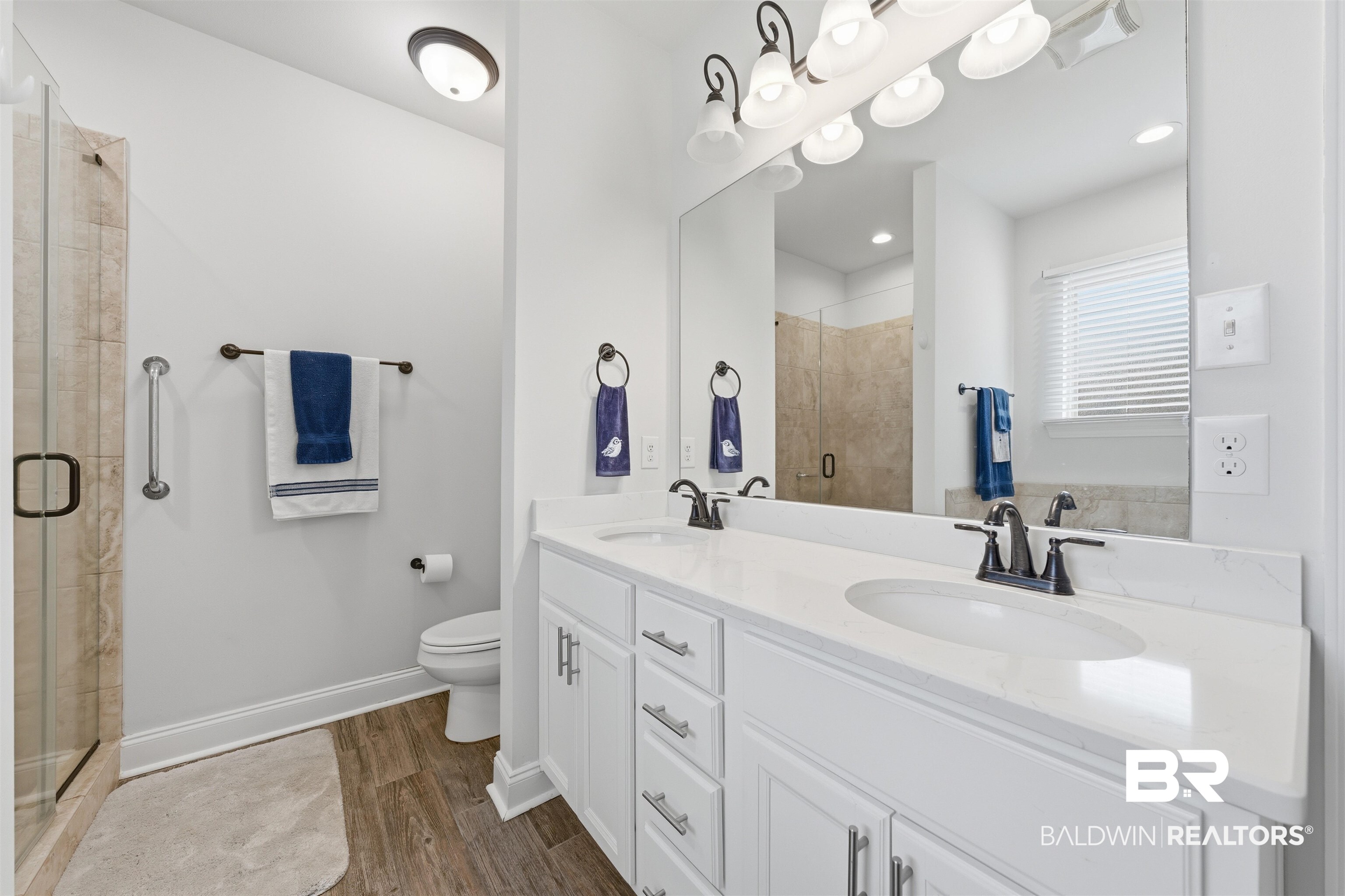22512 Putter Lane Foley, AL 36535 - Photo 15 of 27 Bathroom featuring double vanity, a shower stall, dark wood-style flooring, and recessed lighting