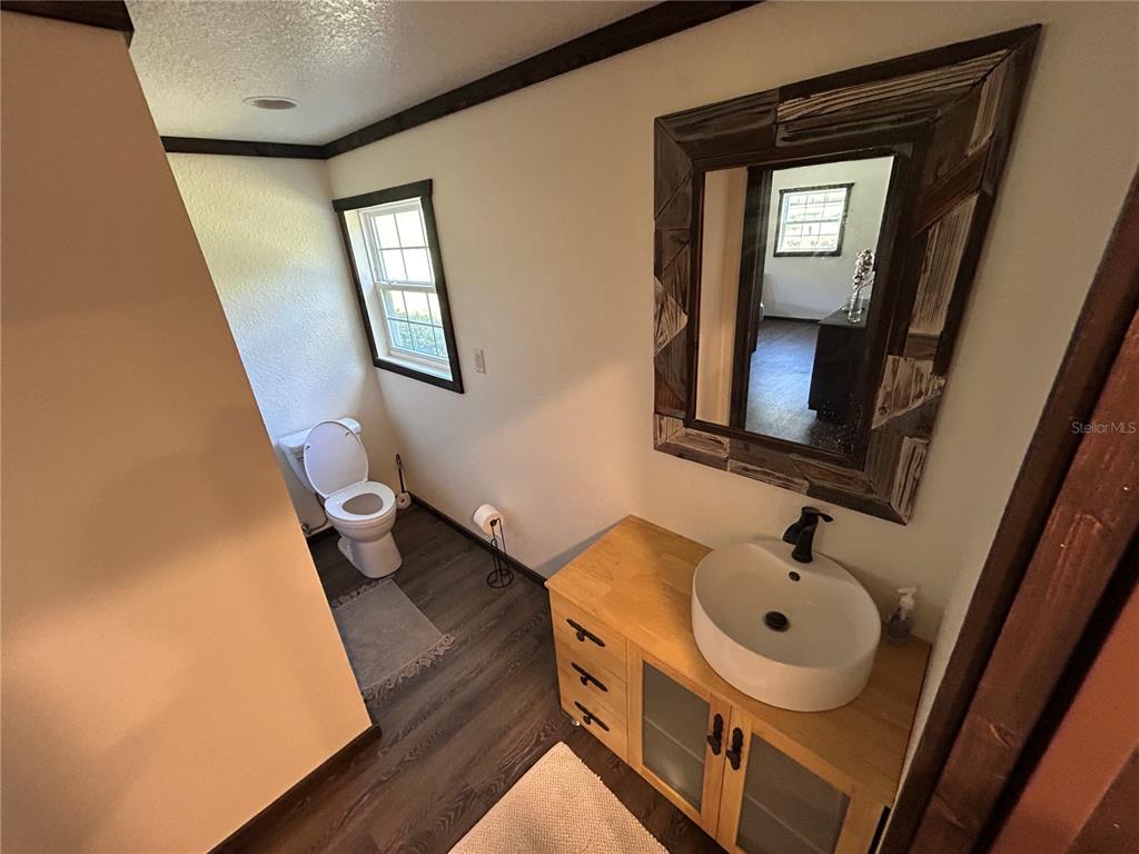15455 Northwest 100th Avenue Road Reddick, FL 32686 - Photo 8 of 10 a bathroom with a sink a toilet and mirror