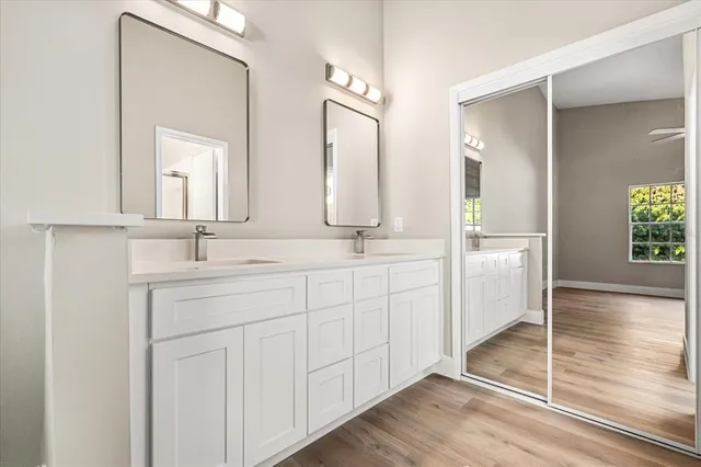 a bathroom with a double vanity sink and a mirror