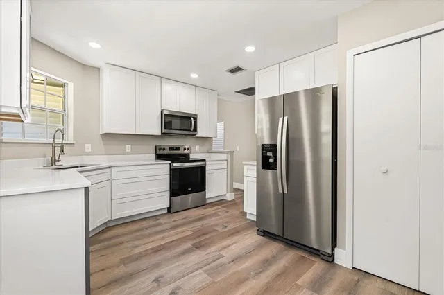 a kitchen with a refrigerator sink and microwave
