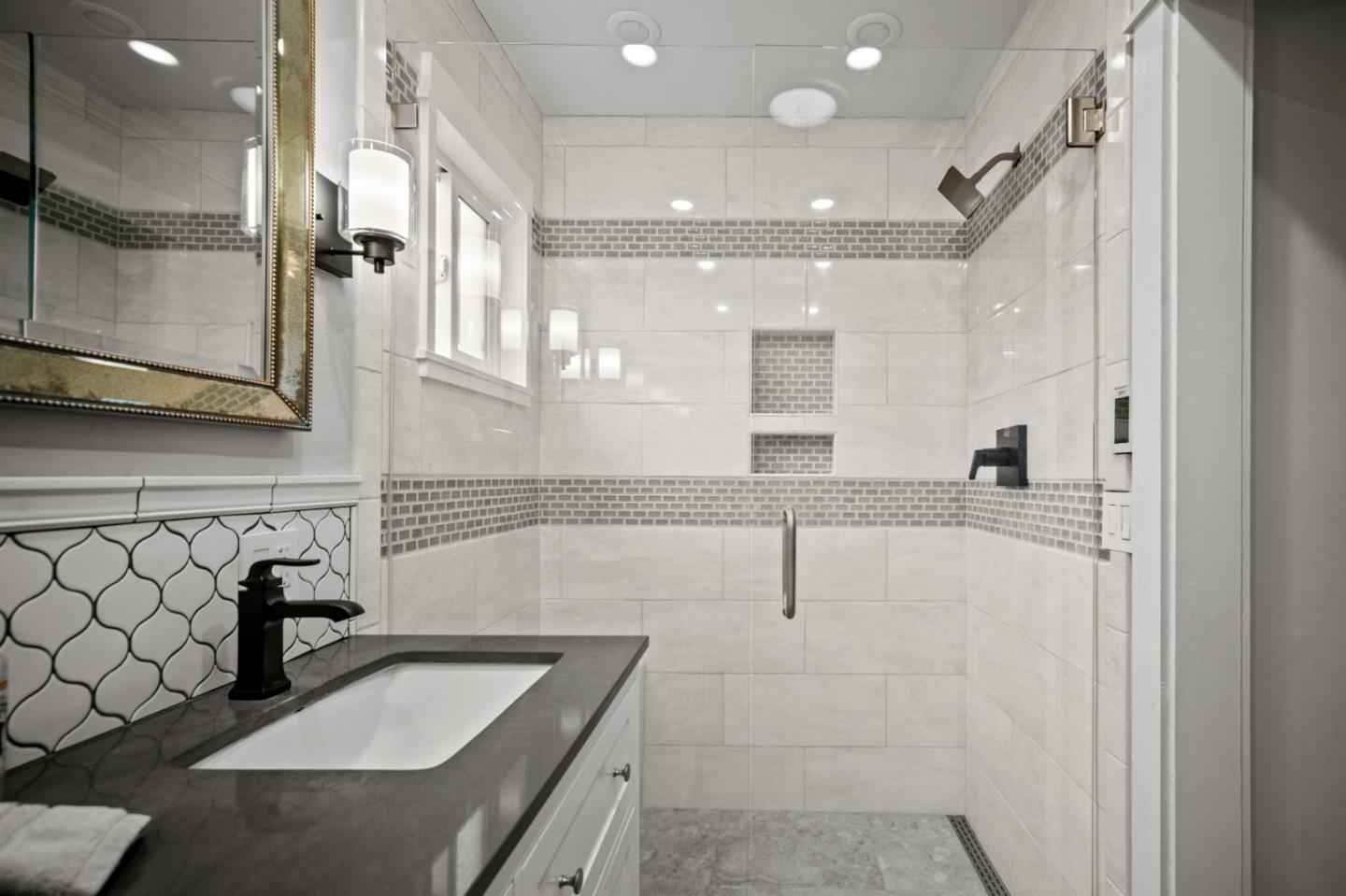 1321 David Avenue Pacific Grove, CA 93950 - Photo 17 of 24 a bathroom with a double vanity sink mirror and shower