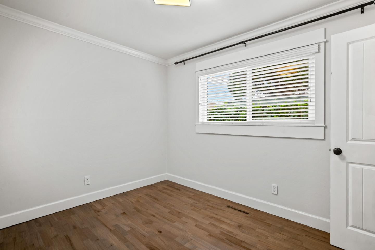 1321 David Avenue Pacific Grove, CA 93950 - Photo 20 of 24 a view of an empty room with wooden floor and a window