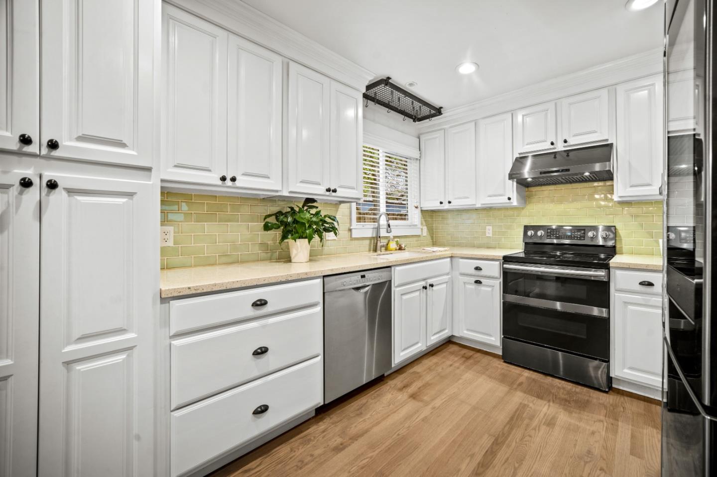 1321 David Avenue Pacific Grove, CA 93950 - Photo 24 of 24 a kitchen with white cabinets and stainless steel appliances