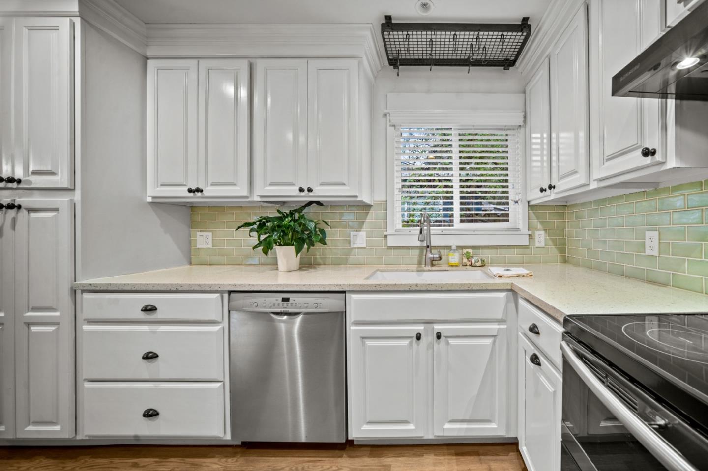 1321 David Avenue Pacific Grove, CA 93950 - Photo 6 of 24 a kitchen with granite countertop white cabinets and white appliances