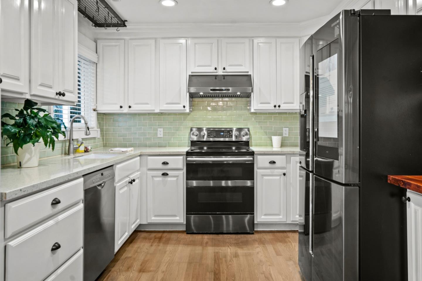 1321 David Avenue Pacific Grove, CA 93950 - Photo 7 of 24 a kitchen with a refrigerator and a stove top oven