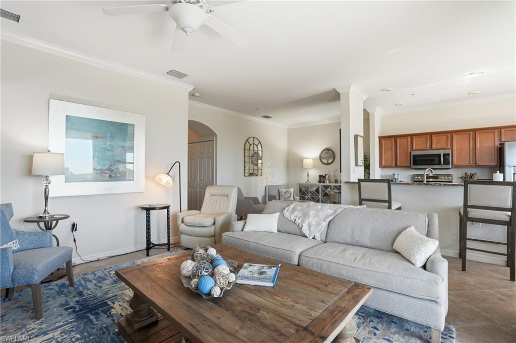 9830 Giaveno Circle, Unit 1646 Naples, FL 34113 - Photo 11 of 30 a living room with furniture kitchen view and a wooden floor