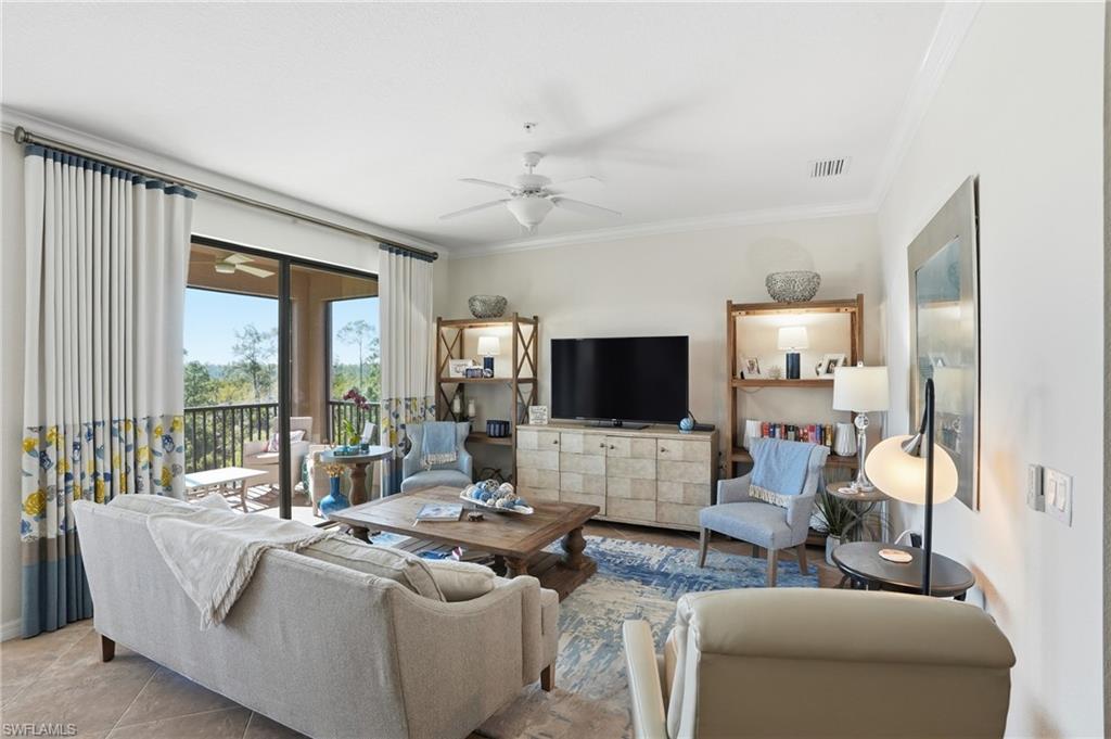 9830 Giaveno Circle, Unit 1646 Naples, FL 34113 - Photo 12 of 30 a living room with furniture and a flat screen tv