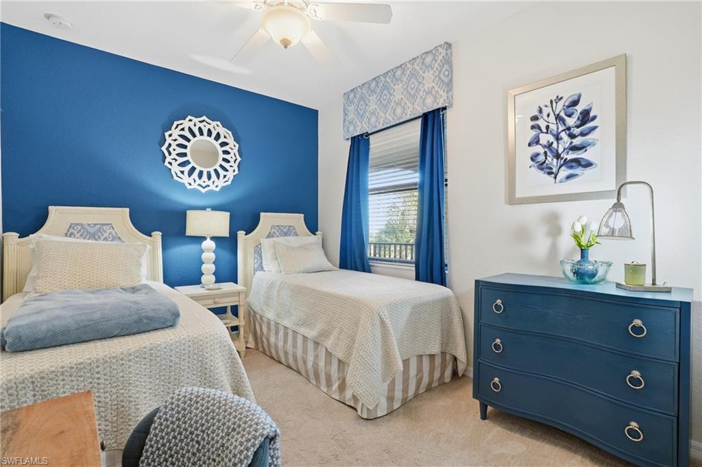 9830 Giaveno Circle, Unit 1646 Naples, FL 34113 - Photo 18 of 30 a bedroom with a bed and a lamp on dresser