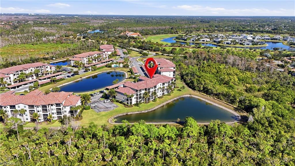 9830 Giaveno Circle, Unit 1646 Naples, FL 34113 - Photo 23 of 30 an aerial view of residential houses with outdoor space and trees
