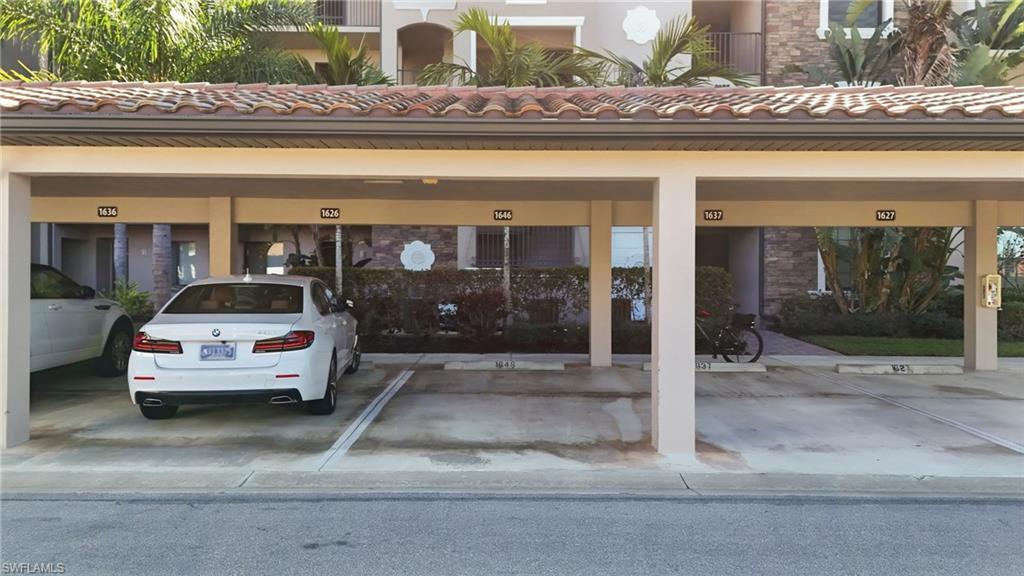 9830 Giaveno Circle, Unit 1646 Naples, FL 34113 - Photo 26 of 30 a car parked in front of a building