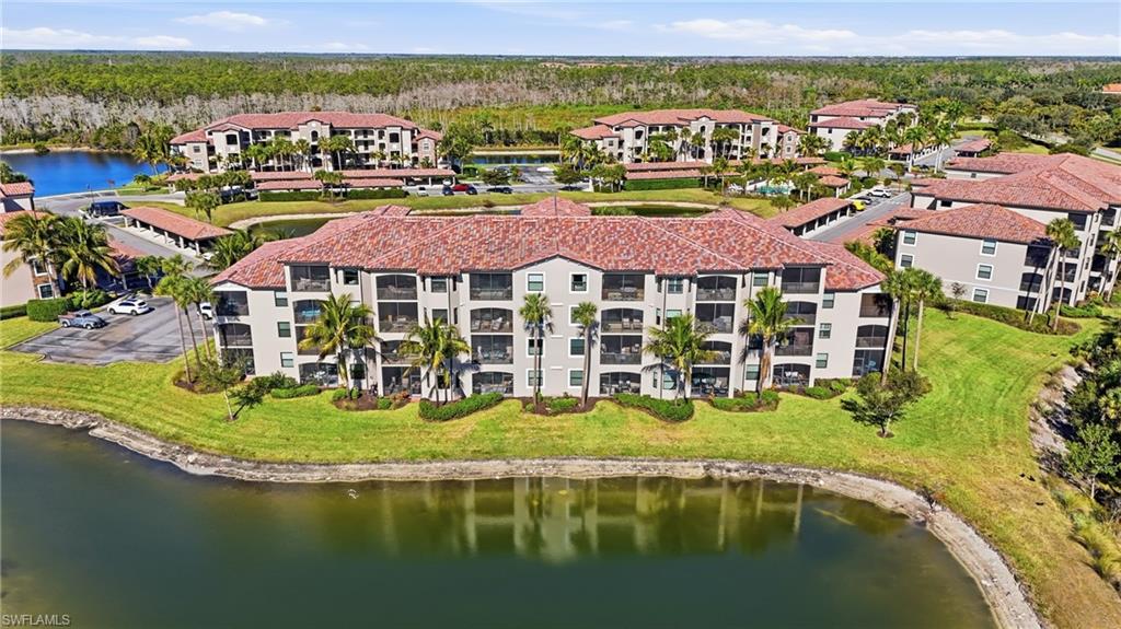 9830 Giaveno Circle, Unit 1646 Naples, FL 34113 - Photo 27 of 30 a view of a lake with houses