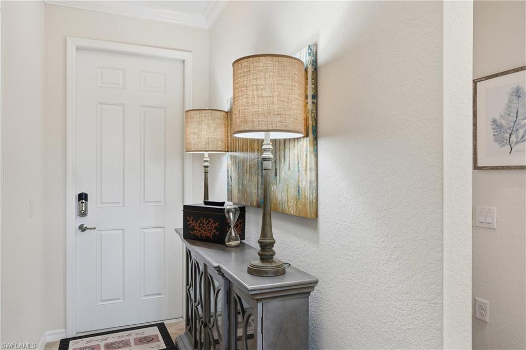 9830 Giaveno Circle, Unit 1646 Naples, FL 34113 - Photo 7 of 30 a front view of a house with wooden floor