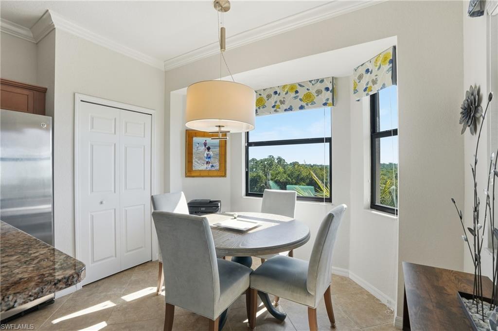 9830 Giaveno Circle, Unit 1646 Naples, FL 34113 - Photo 8 of 30 a view of a dining room with furniture window and wooden floor
