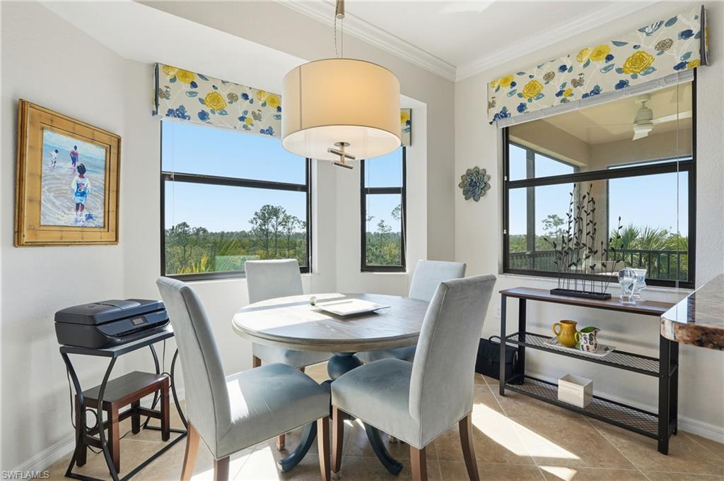 9830 Giaveno Circle, Unit 1646 Naples, FL 34113 - Photo 9 of 30 a view of a dining room with furniture a chandelier and a large window