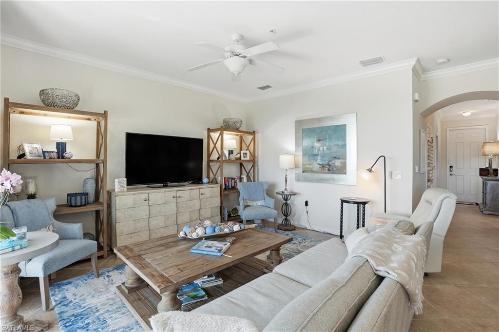 9830 Giaveno Circle, Unit 1646 Naples, FL 34113 - Photo 10 of 30 a living room with furniture a rug and a flat screen tv