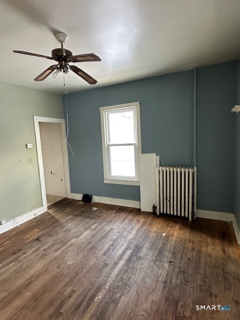 7-9 Cook Street Ansonia, CT 06401 - Photo 16 of 17 an empty room with wooden floor a ceiling fan and windows