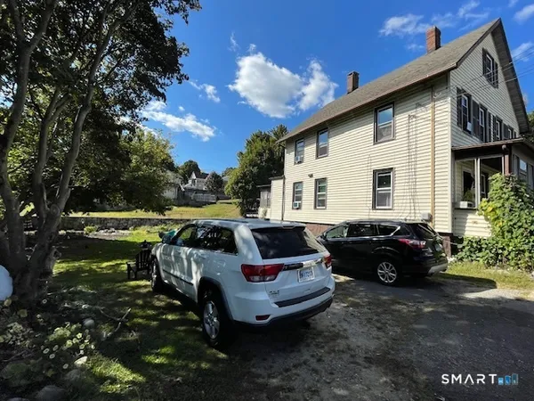 a view of a house with backyard sitting area and garden