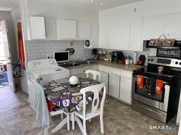 a kitchen with a stove a sink and a refrigerator