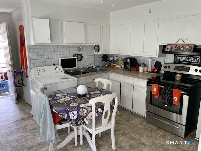7-9 Cook Street Ansonia, CT 06401 - Photo 7 of 17 a kitchen with a stove a sink and a refrigerator