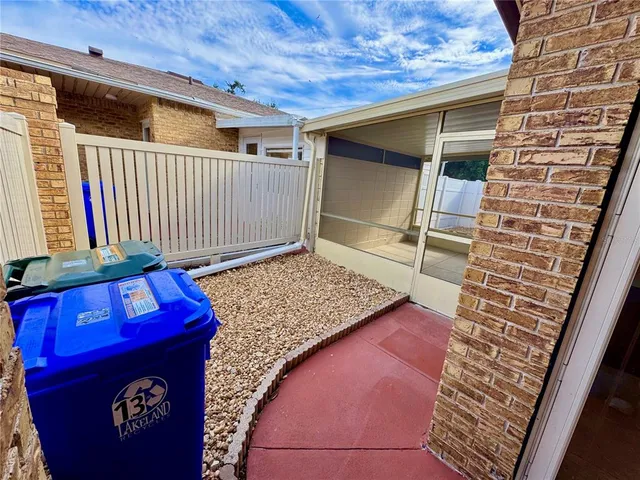 a view of a swimming pool with a patio and plants