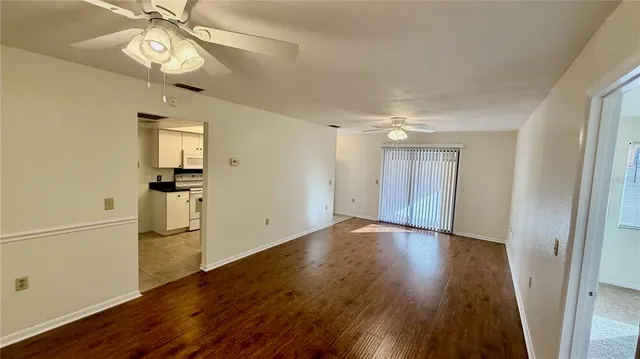 a view of an empty room with wooden floor