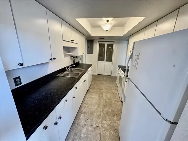 a kitchen with a sink appliances and cabinets