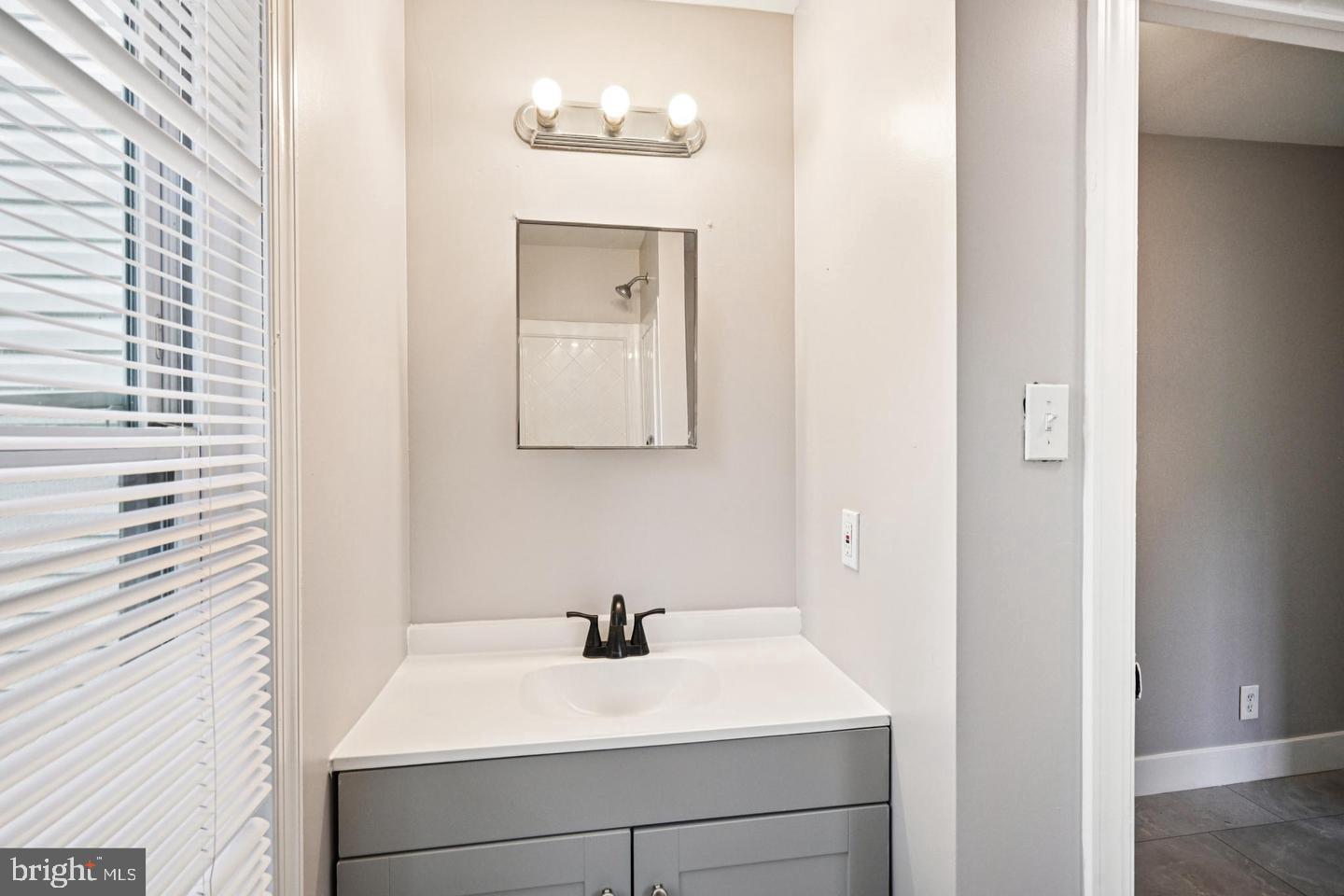 134 South Main Street Glassboro, NJ 08028 - Photo 4 of 6 a bathroom with a sink and a mirror