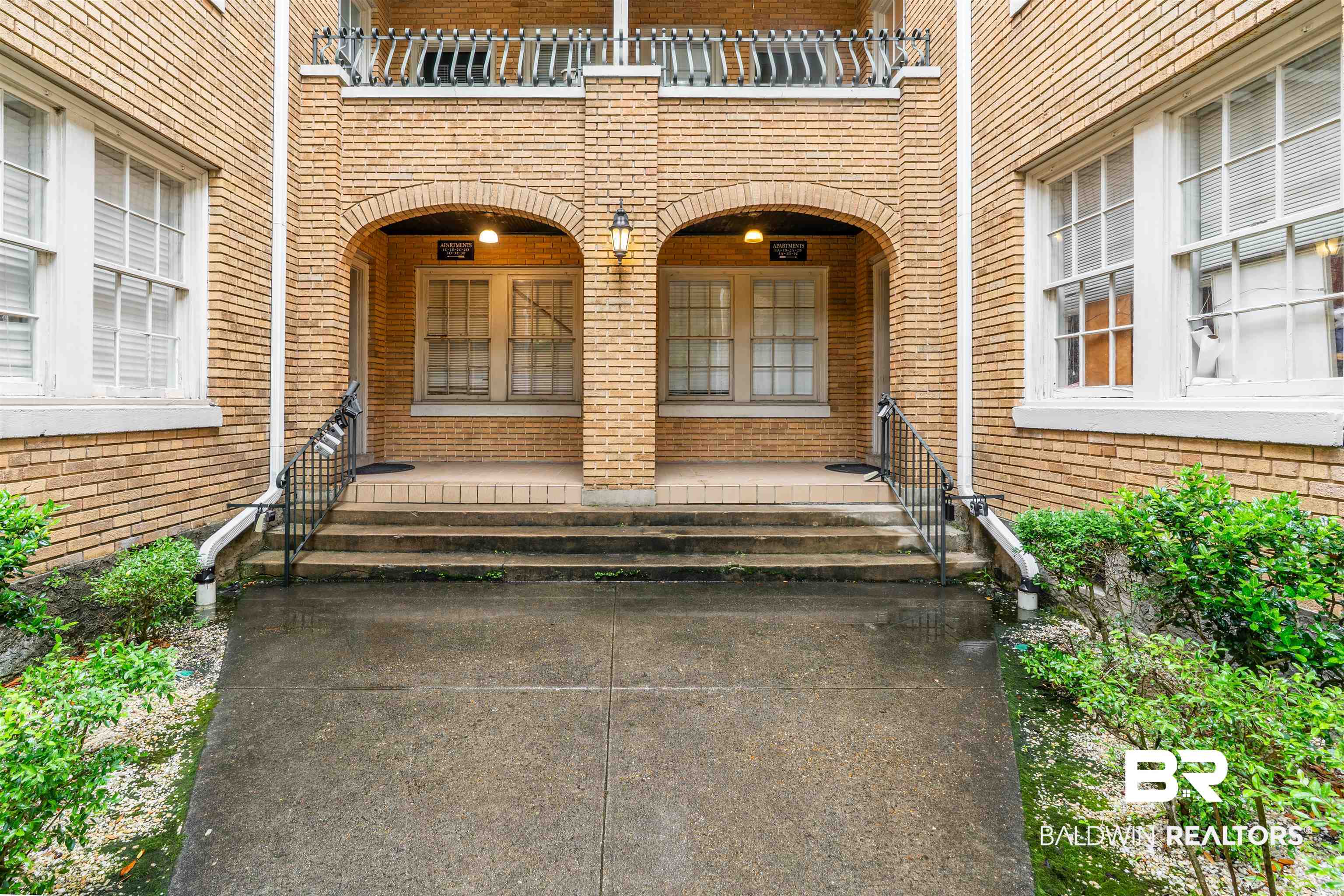 1600 Government Street, Unit 3F Mobile, AL 36604 - Photo 2 of 18 Property entrance with brick siding, a porch, and a balcony