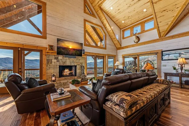 a view of a kitchen with stainless steel appliances granite countertop a stove and a wooden floors