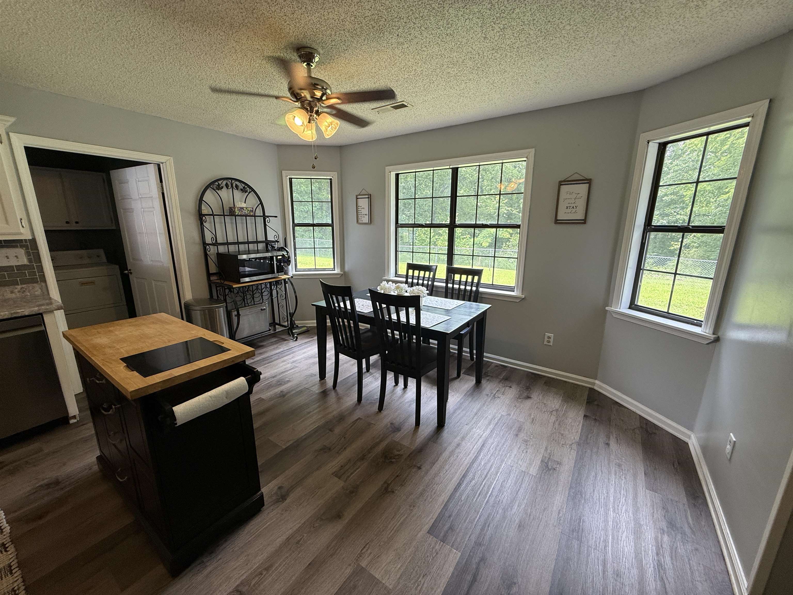 185 Mignon Road Atoka, TN 38004 - Photo 30 of 34 Kitchen area featuring wood-finish flooring, a ceiling fan with integrated lighting, and multiple windows