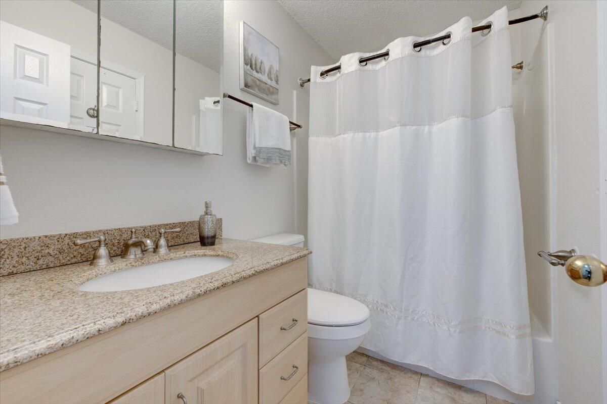 803 Valley Road Crestview, FL 32539 - Photo 21 of 22 a bathroom with a granite countertop sink and a mirror