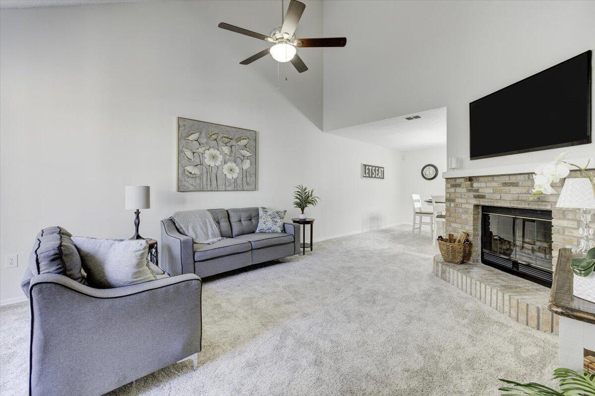 803 Valley Road Crestview, FL 32539 - Photo 5 of 22 a living room with furniture a flat screen tv and a fireplace