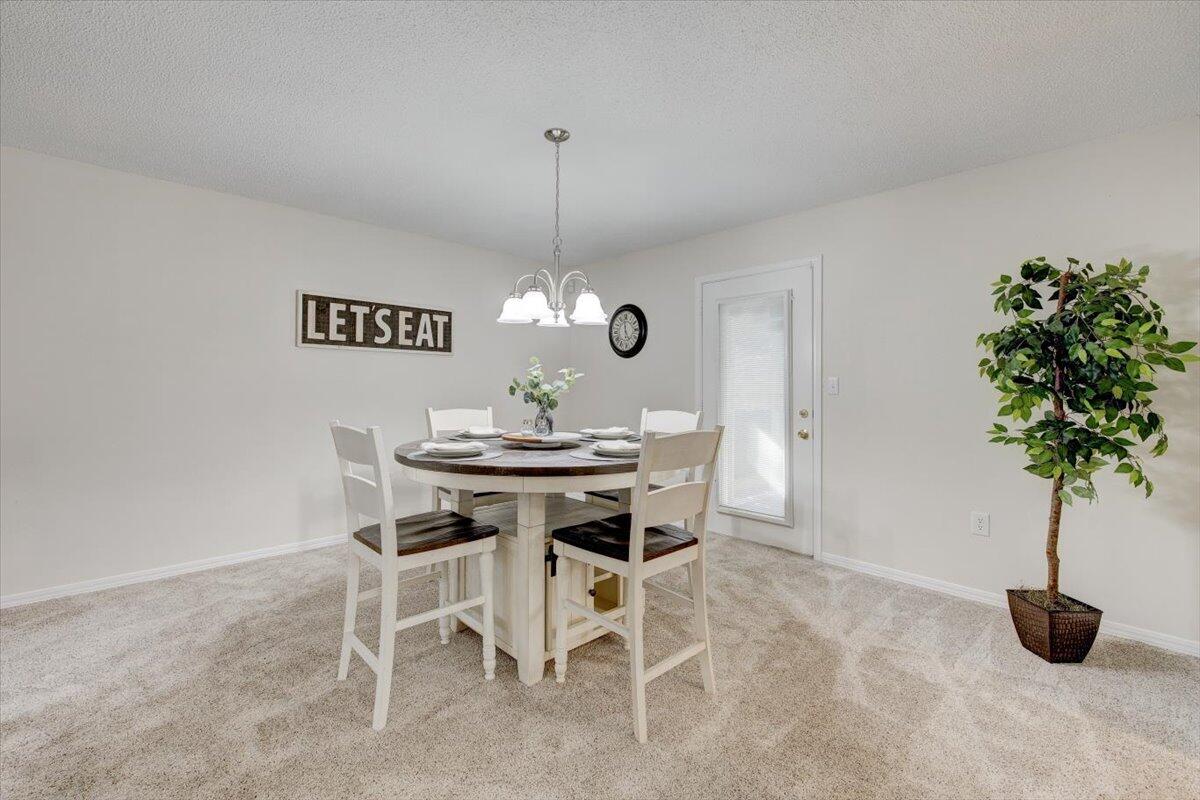803 Valley Road Crestview, FL 32539 - Photo 9 of 22 a dining room with furniture and potted plant