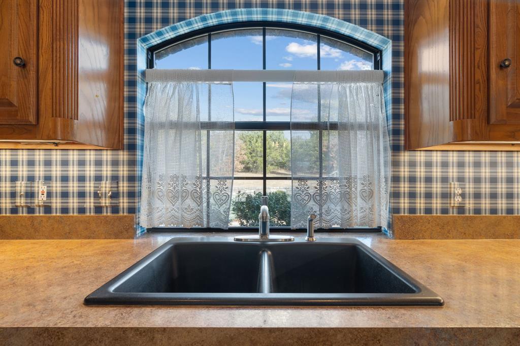1317 Timber Ridge Road Weatherford, TX 76088 - Photo 11 of 40 a view of a kitchen with a sink and cabinets