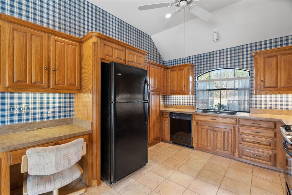 1317 Timber Ridge Road Weatherford, TX 76088 - Photo 12 of 40 a kitchen with stainless steel appliances granite countertop a stove a sink and dishwasher