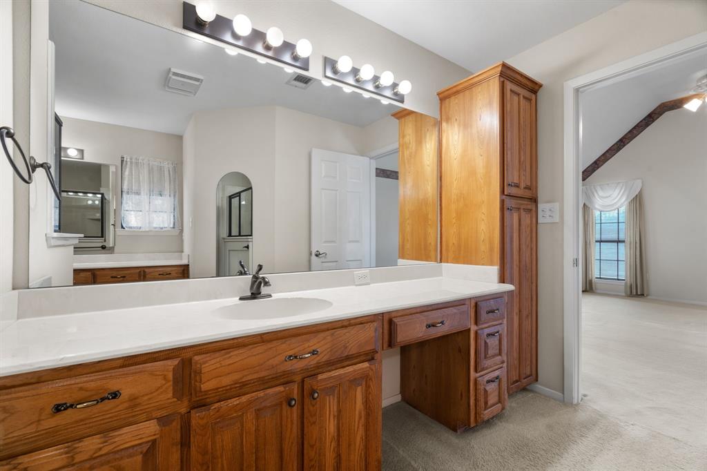 1317 Timber Ridge Road Weatherford, TX 76088 - Photo 19 of 40 a bathroom with a sink double vanity and a mirror