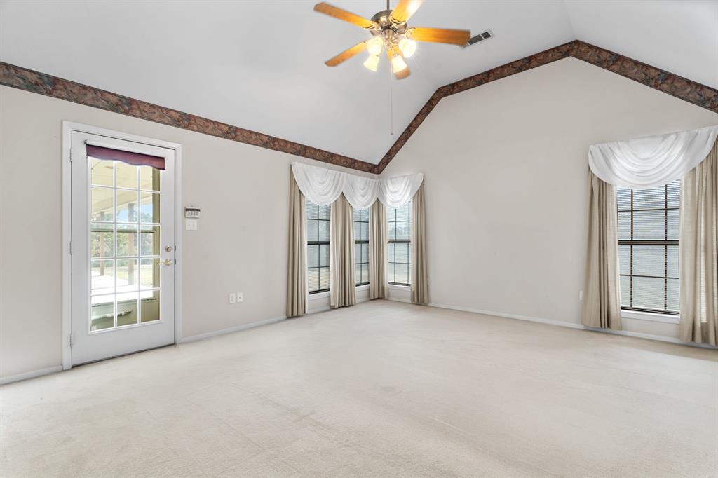 1317 Timber Ridge Road Weatherford, TX 76088 - Photo 20 of 40 an empty room with windows and ceiling fan
