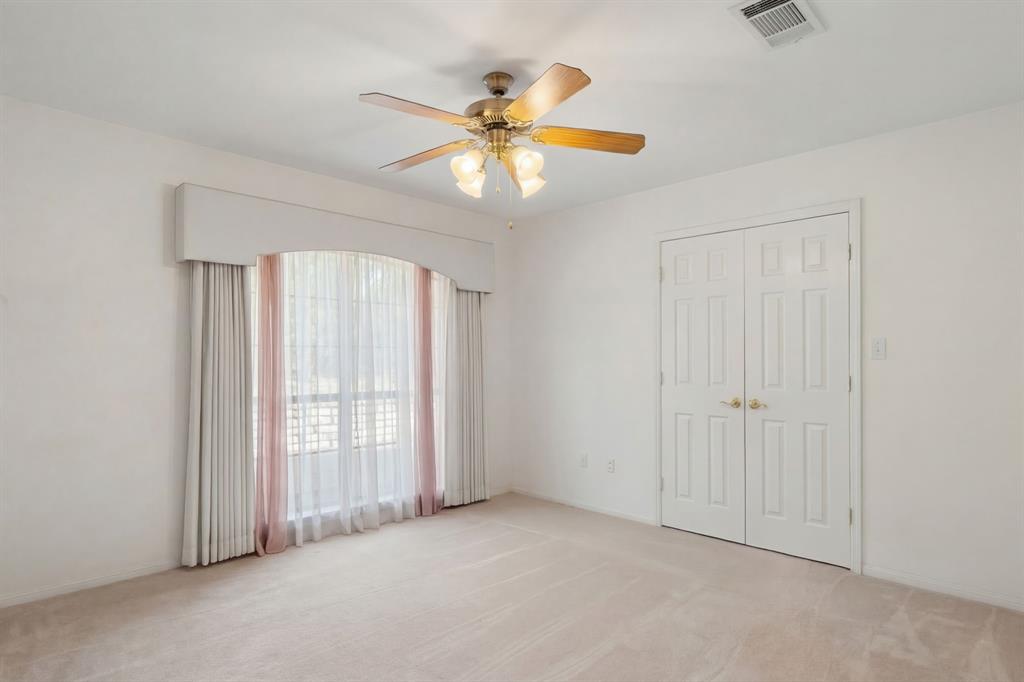 1317 Timber Ridge Road Weatherford, TX 76088 - Photo 24 of 40 an empty room with windows and fan