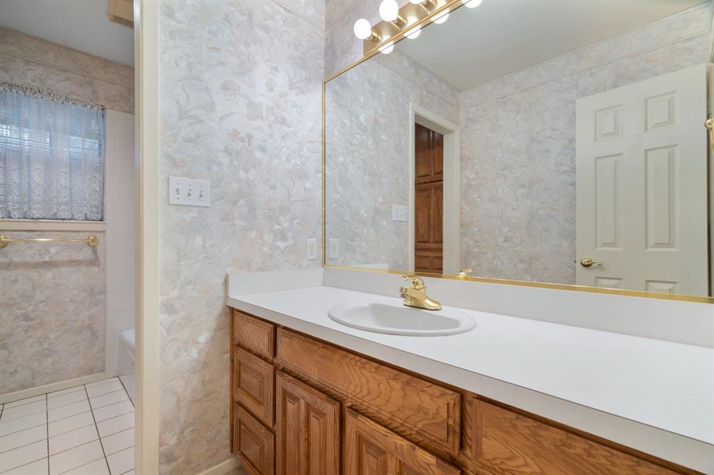1317 Timber Ridge Road Weatherford, TX 76088 - Photo 25 of 40 a bathroom with a sink and a mirror