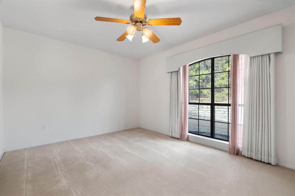 1317 Timber Ridge Road Weatherford, TX 76088 - Photo 26 of 40 an empty room with windows and fan