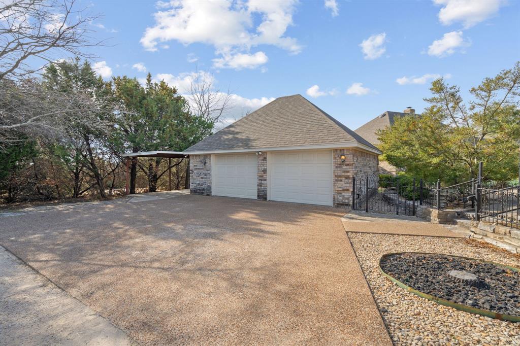 1317 Timber Ridge Road Weatherford, TX 76088 - Photo 28 of 40 a view of a house with a yard and garage