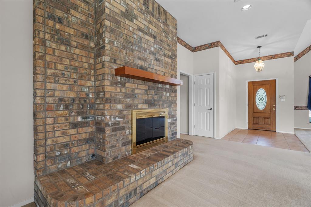 1317 Timber Ridge Road Weatherford, TX 76088 - Photo 4 of 40 a view of empty room with a fireplace