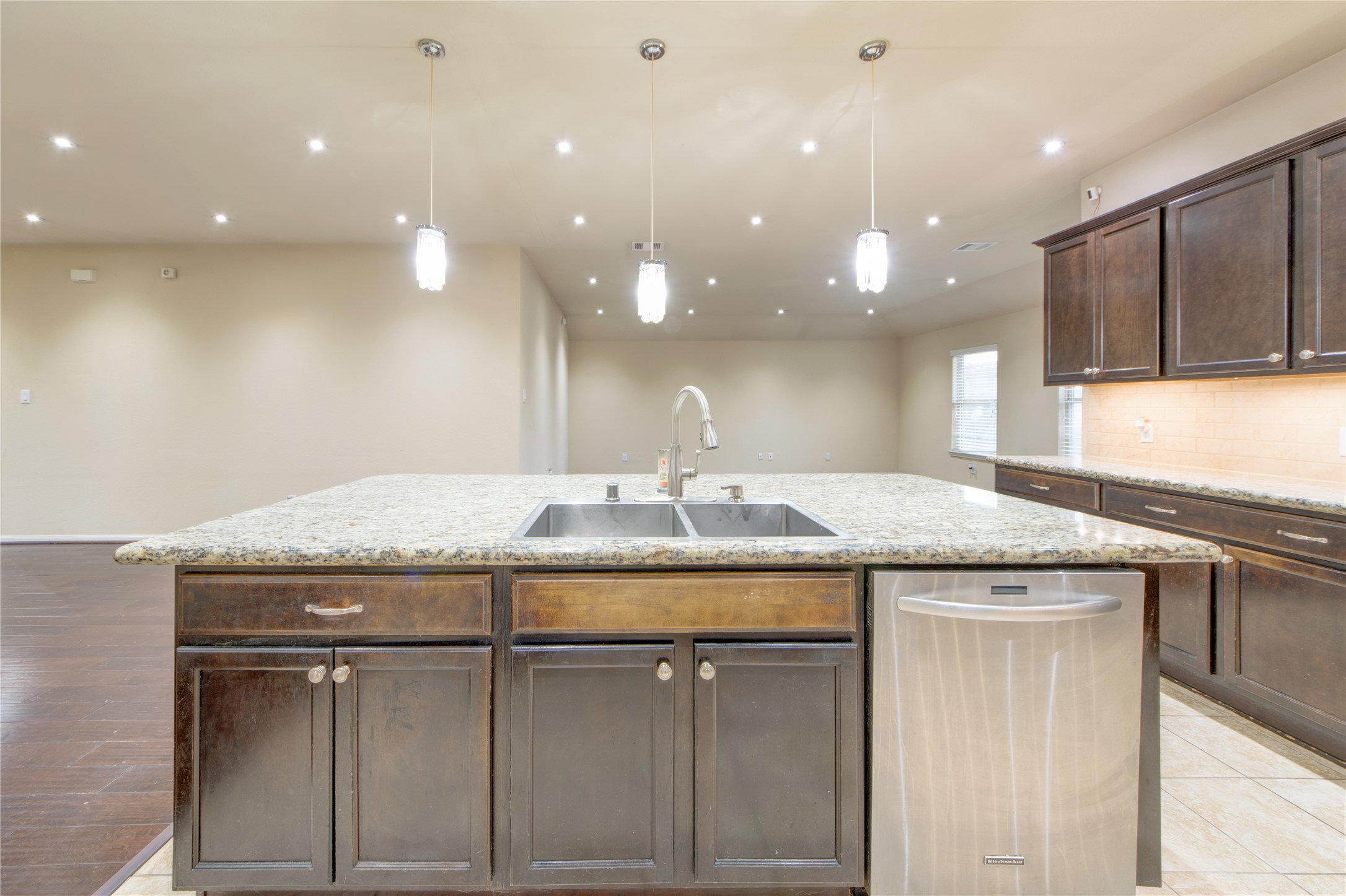 9322 Limestone Ranch Lane Richmond, TX 77407 - Photo 11 of 40 a kitchen with kitchen island a sink and a refrigerator