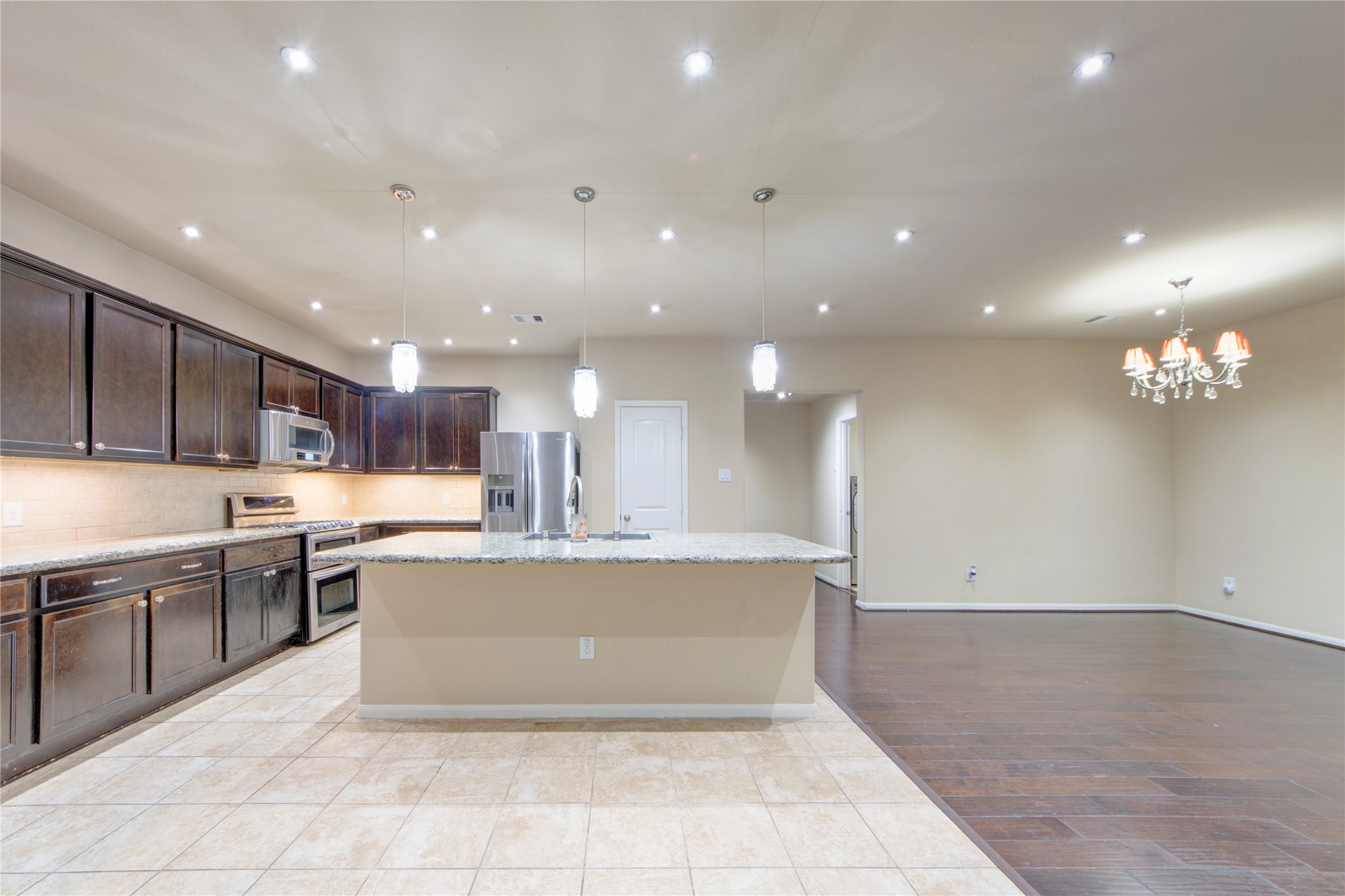 9322 Limestone Ranch Lane Richmond, TX 77407 - Photo 13 of 40 a large kitchen with stainless steel appliances lots of counter top space